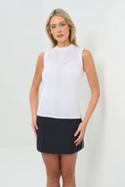 Front view Sleeveless white mock-neck knit top featuring delicate detailing across the upper chest and a vertical textured stripe down the center front. Fitted silhouette for a sleek, polished look.